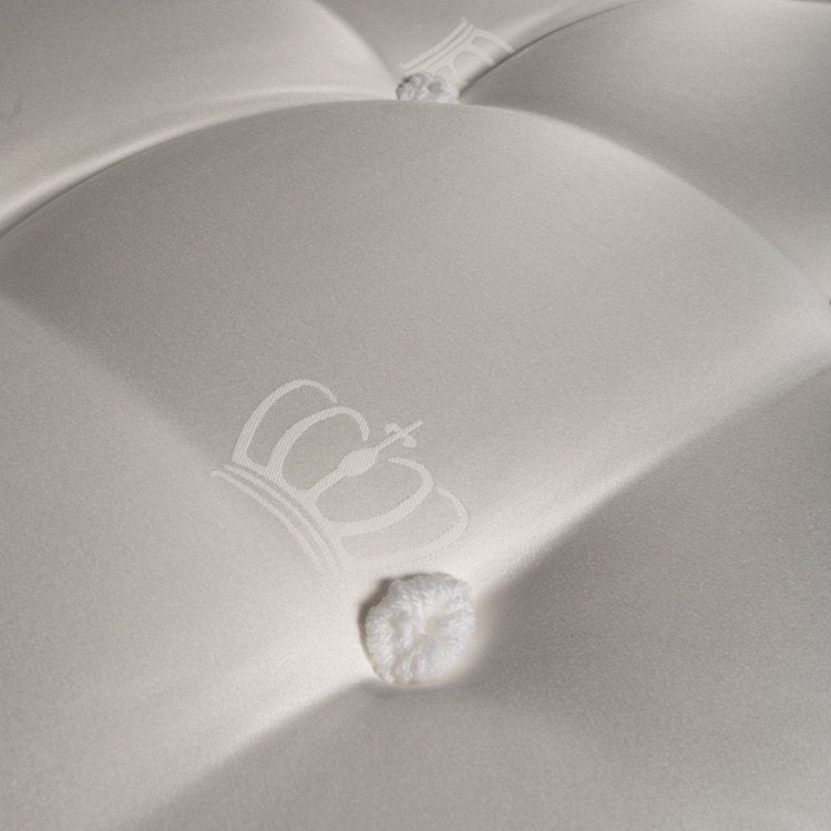 Close-up shot of the elite 30 hand-tailored tufts securing the comfort layers on a Chattam and Wells Ashford bed.