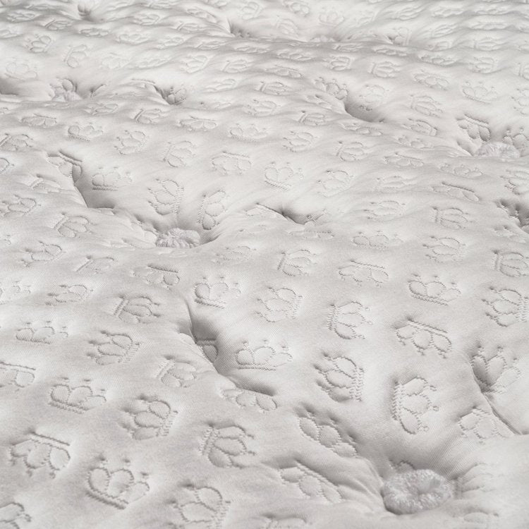 Close-up of the traditional 20 hand-tailored tufts on the luxury plush Chattam and Wells Chantilly bed.